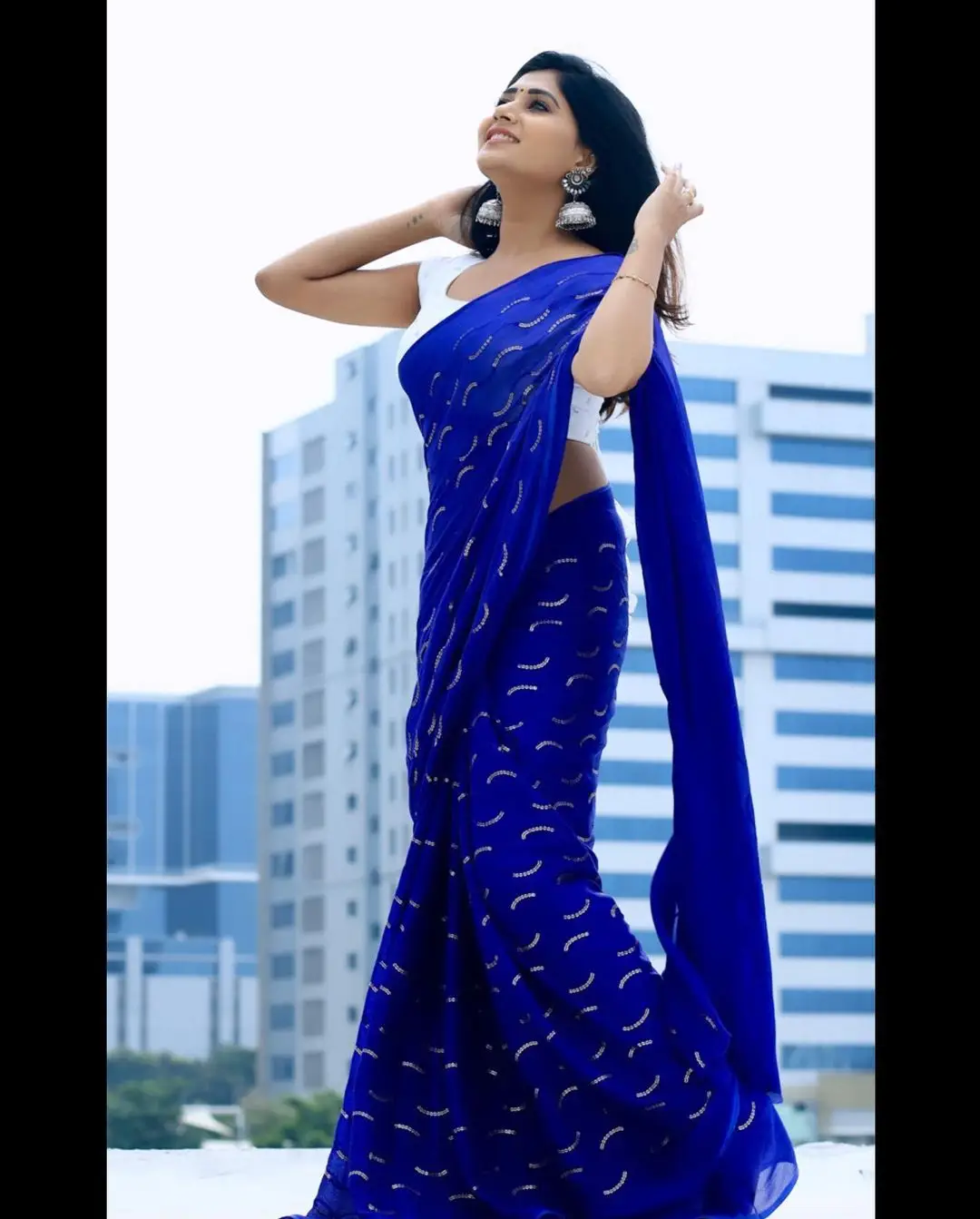 Vasanthi Krishnan Wearing Blue Saree White Sleeveless Blouse